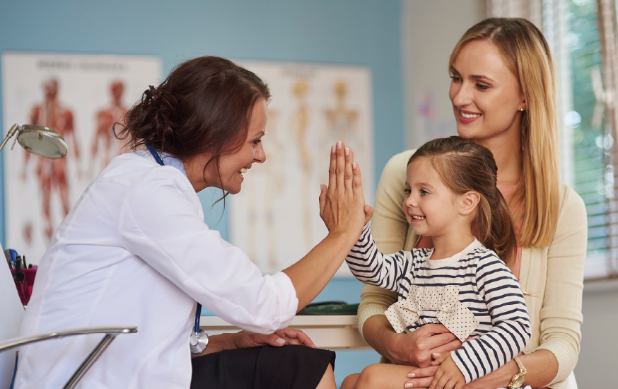 Doctor high five to child patient