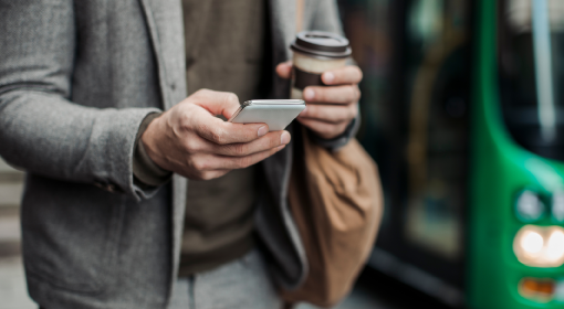 man using phone in transit