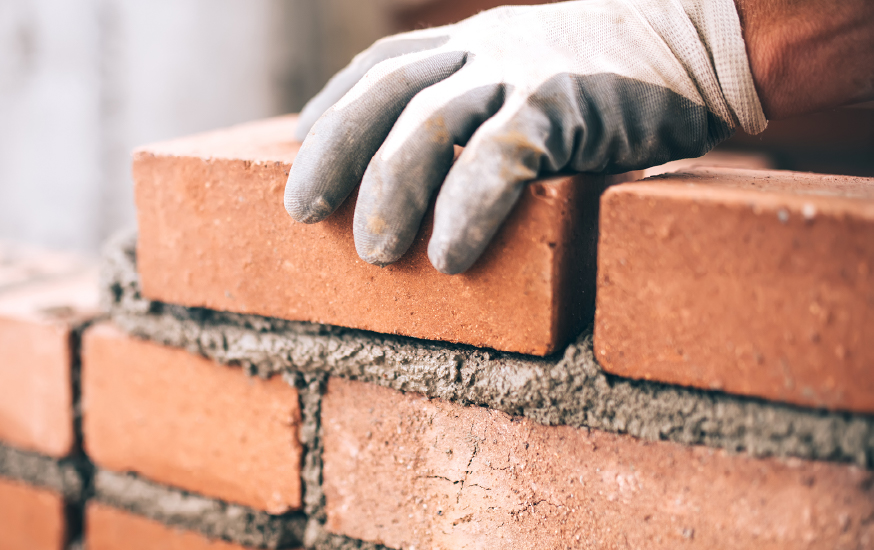 person laying bricks