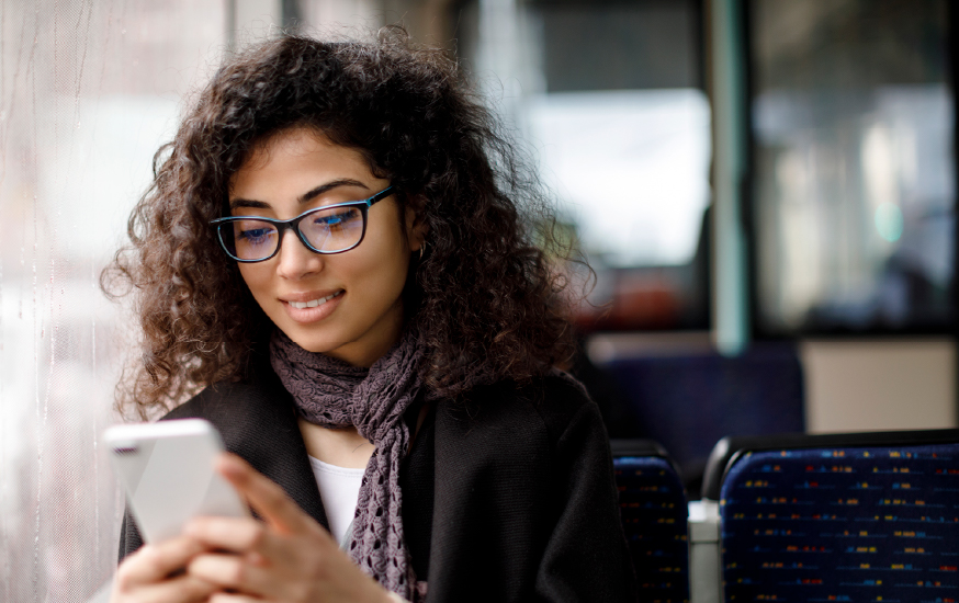 woman mobile banking on bus