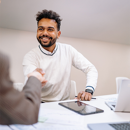 man at a desk shaking hands