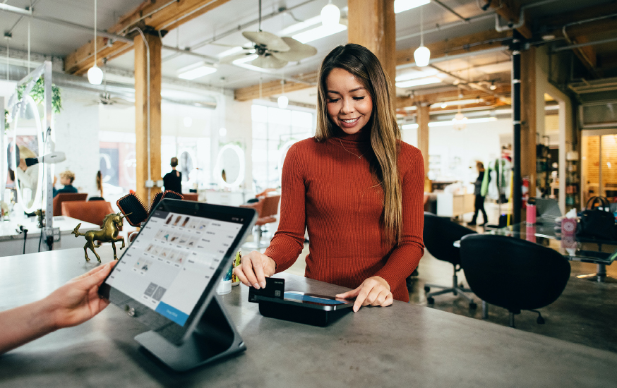 woman making a credit card purchase at store