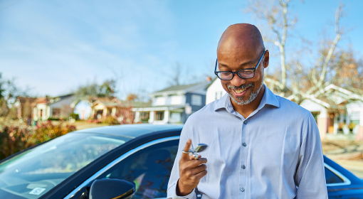 man happy about new car