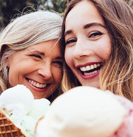 mother and daughter smiling holding ice cream cones