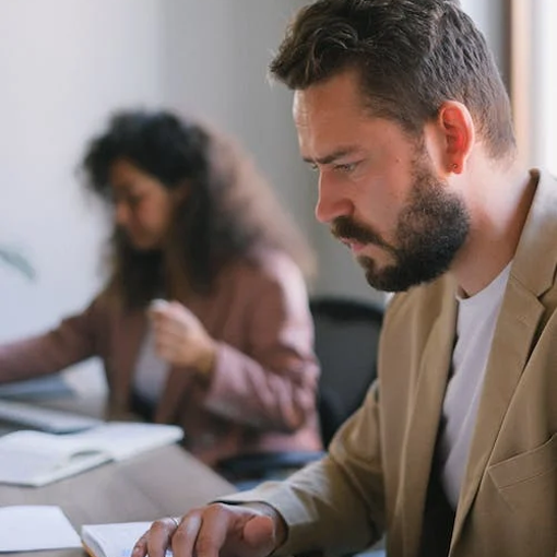 bearded man working on a laptop