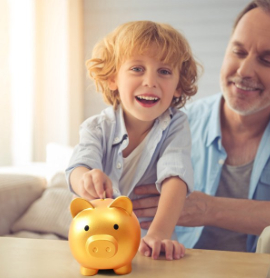 a child and parent with a gold piggy bank