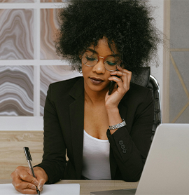 business woman on phone writing on paper