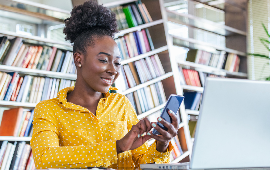 woman using mobile app in library